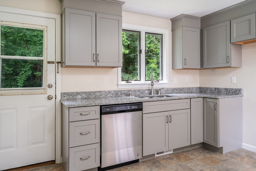 720 Russell Road, Unit C Westfield, MA 01085 - Photo 8 of 26 a kitchen with granite countertop white cabinets and a window