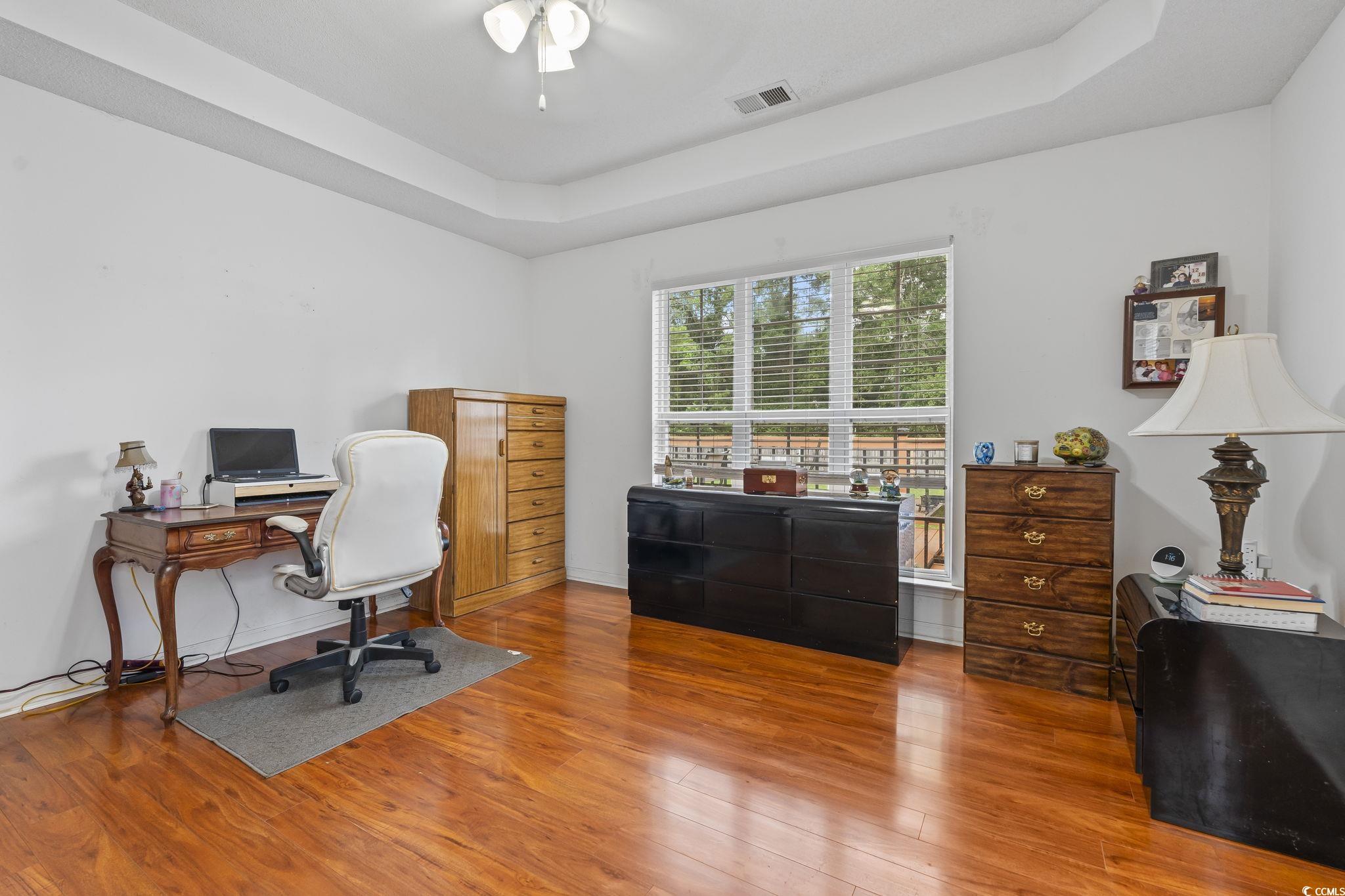 154 Hummingbird Court Myrtle Beach, SC 29579 - Photo 18 of 38 Office featuring a raised ceiling, wood finished floors, and a ceiling fan