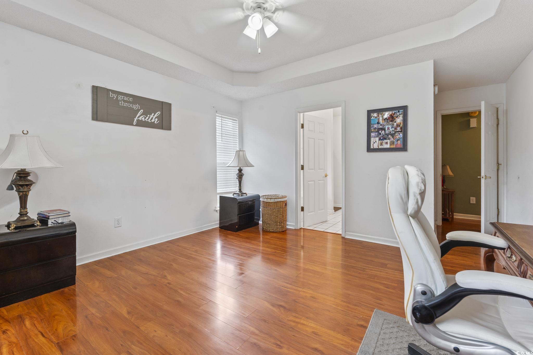 154 Hummingbird Court Myrtle Beach, SC 29579 - Photo 19 of 38 Office with wood finished floors, a raised ceiling, and a ceiling fan