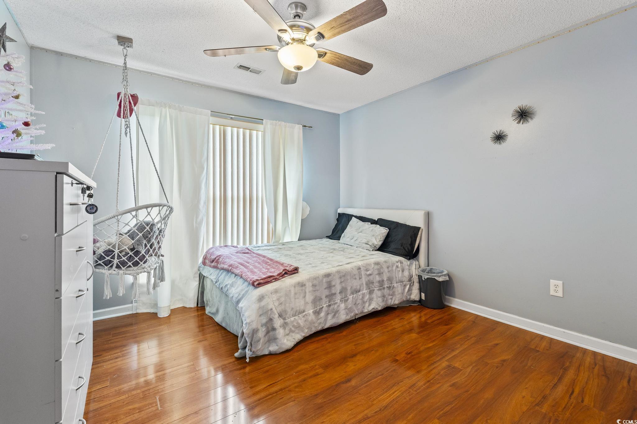 154 Hummingbird Court Myrtle Beach, SC 29579 - Photo 23 of 38 Bedroom with wood finished floors, a textured ceiling, and a ceiling fan