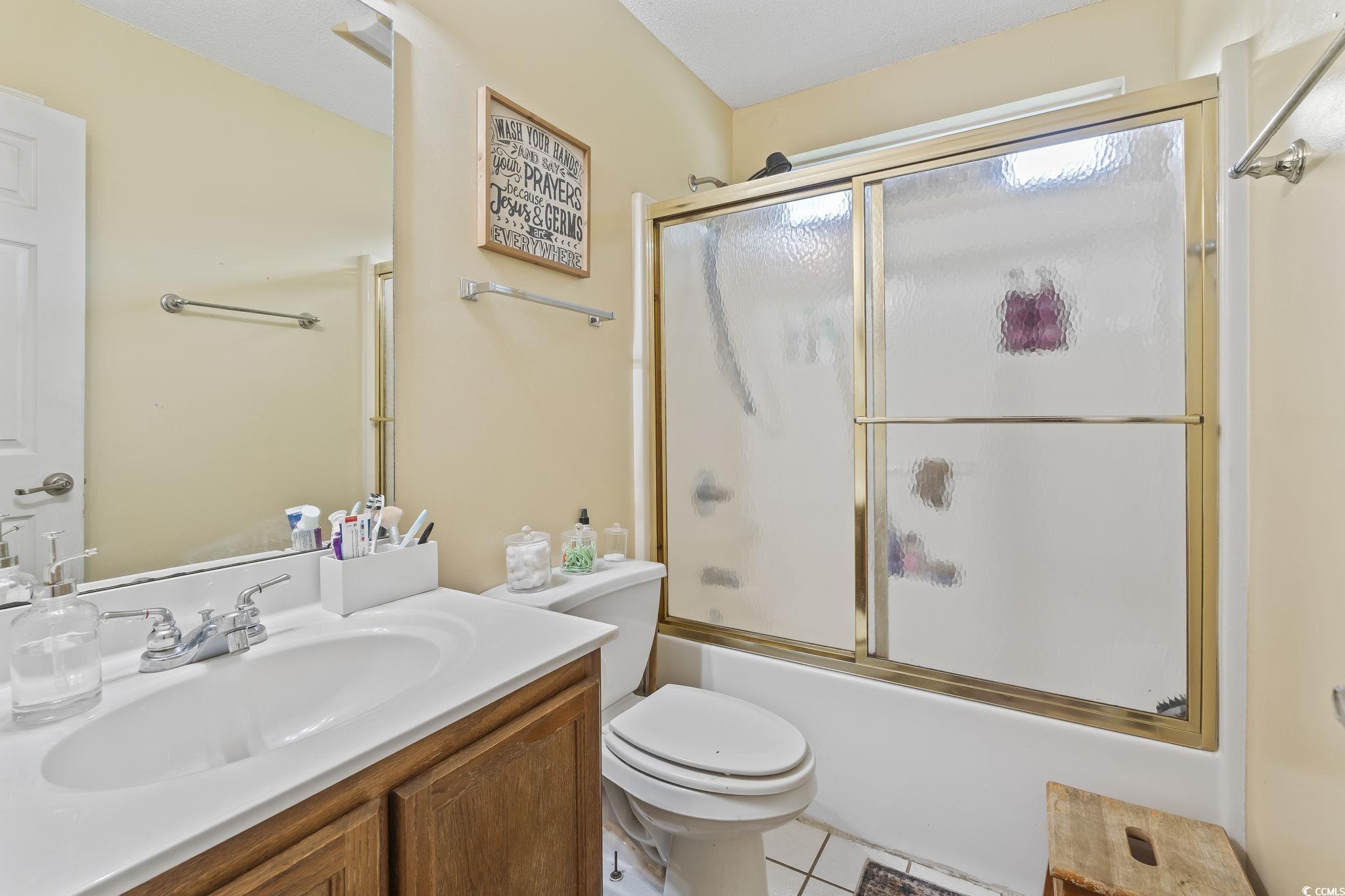 154 Hummingbird Court Myrtle Beach, SC 29579 - Photo 24 of 38 Bathroom featuring enclosed tub / shower combo, vanity, and light tile patterned flooring