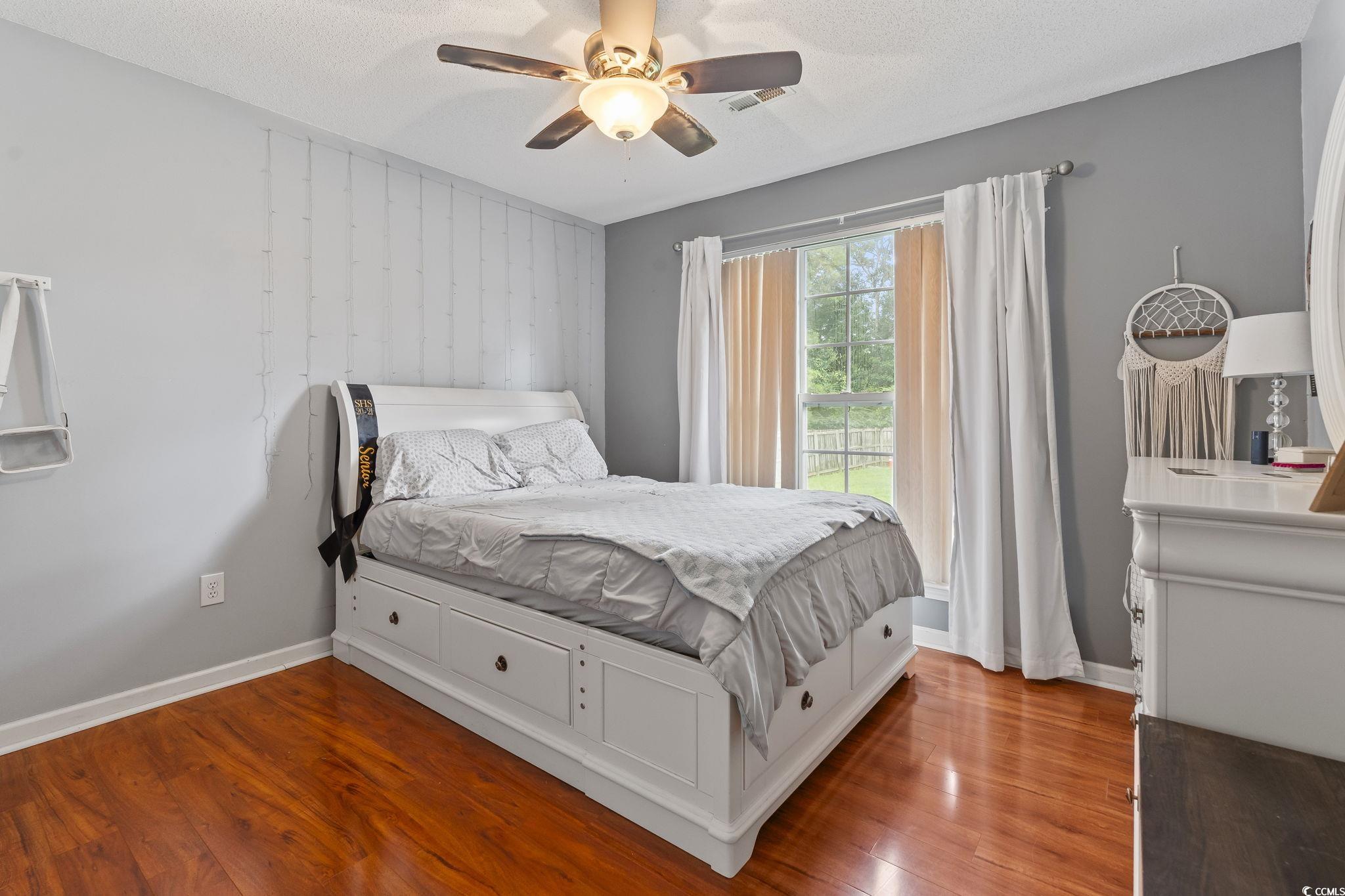 154 Hummingbird Court Myrtle Beach, SC 29579 - Photo 25 of 38 Bedroom with wood finished floors, ceiling fan, and a textured ceiling