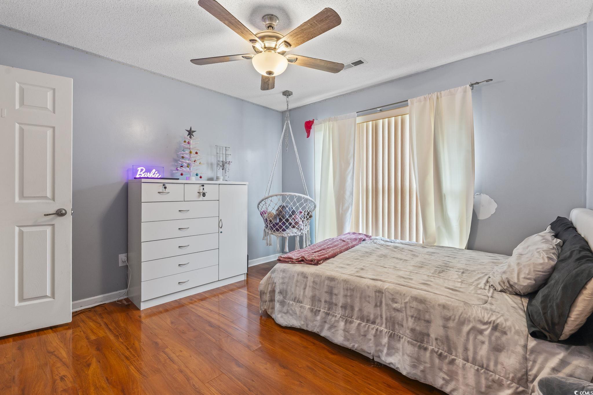 154 Hummingbird Court Myrtle Beach, SC 29579 - Photo 27 of 38 Bedroom featuring wood finished floors, a ceiling fan, and a textured ceiling