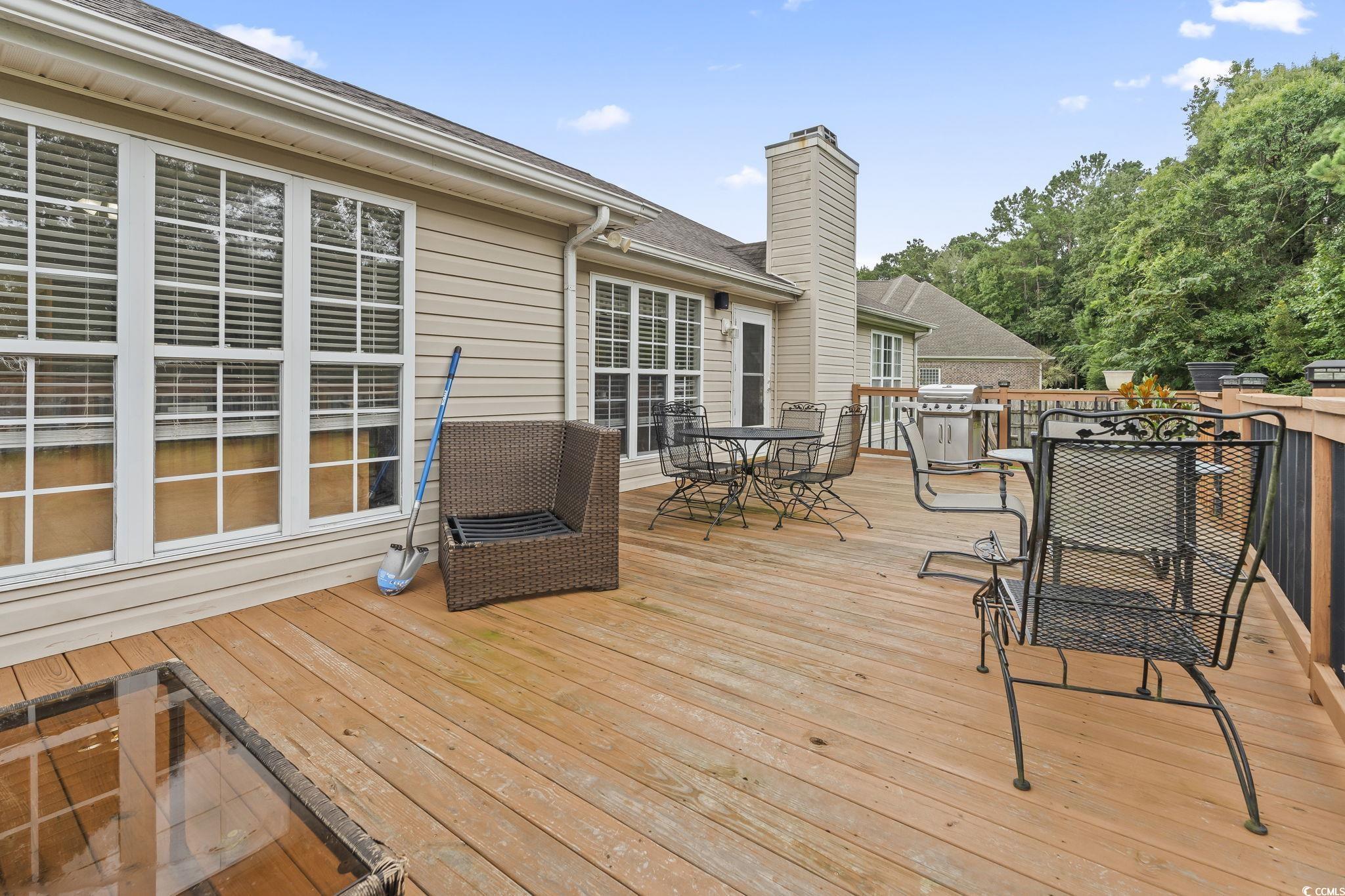 154 Hummingbird Court Myrtle Beach, SC 29579 - Photo 30 of 38 Wooden terrace with outdoor dining area and area for grilling
