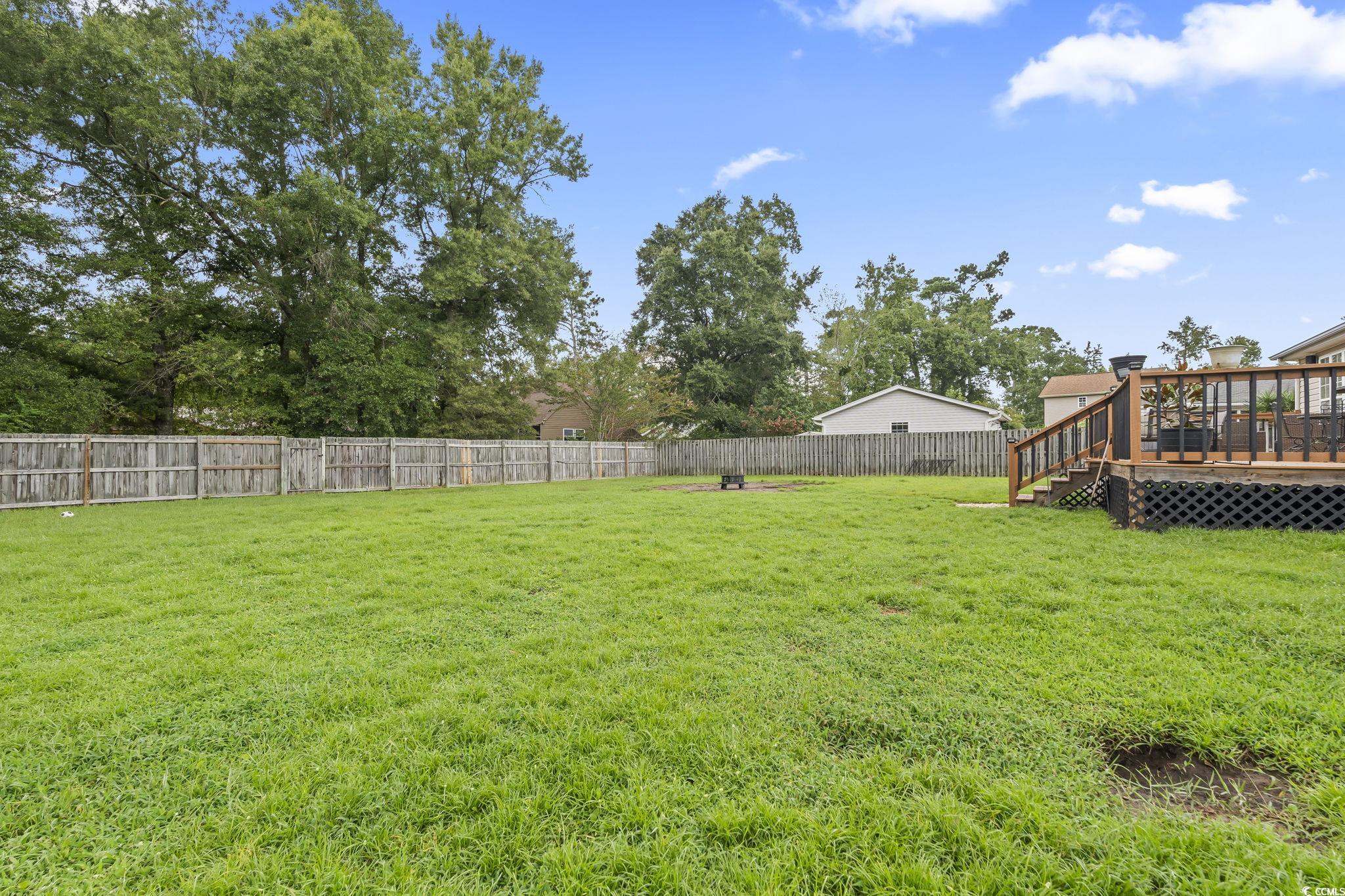 154 Hummingbird Court Myrtle Beach, SC 29579 - Photo 31 of 38 Fenced backyard with a wooden deck