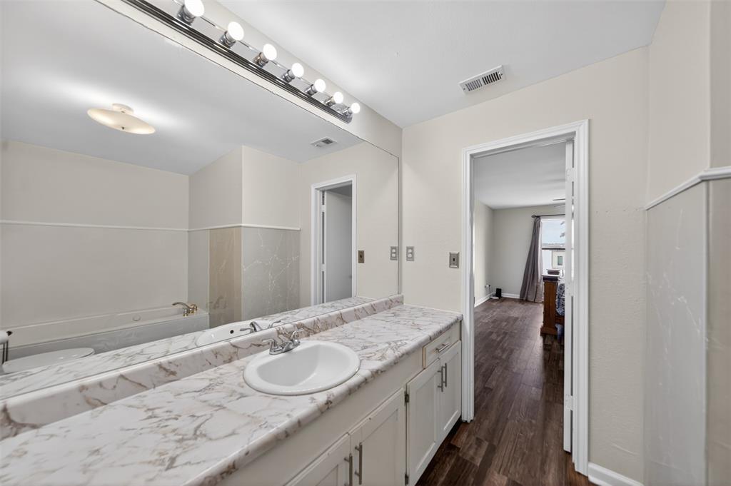 23363 Wateridge Loop Flint, TX 75762 - Photo 34 of 40 a spacious bathroom with a granite countertop double vanity sink and a mirror