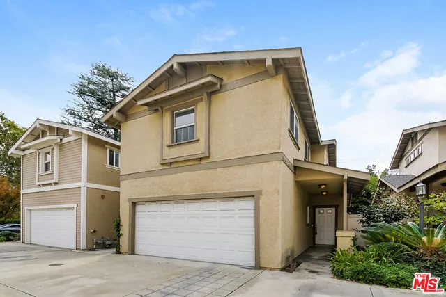 a front view of a house with a garage