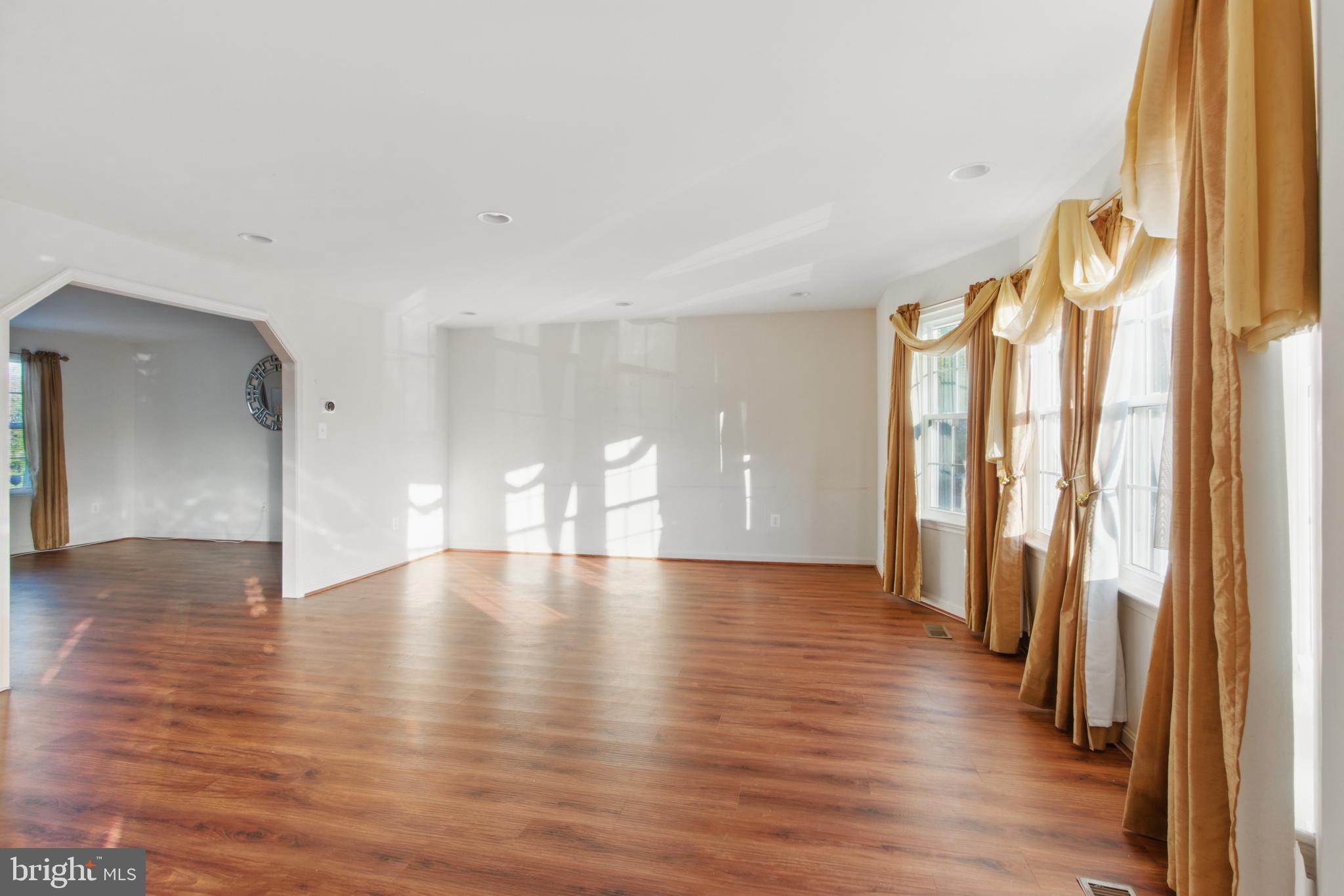 3443 Chapman Road Randallstown, MD 21133 - Photo 25 of 56 a view of an empty room with wooden floor and a window