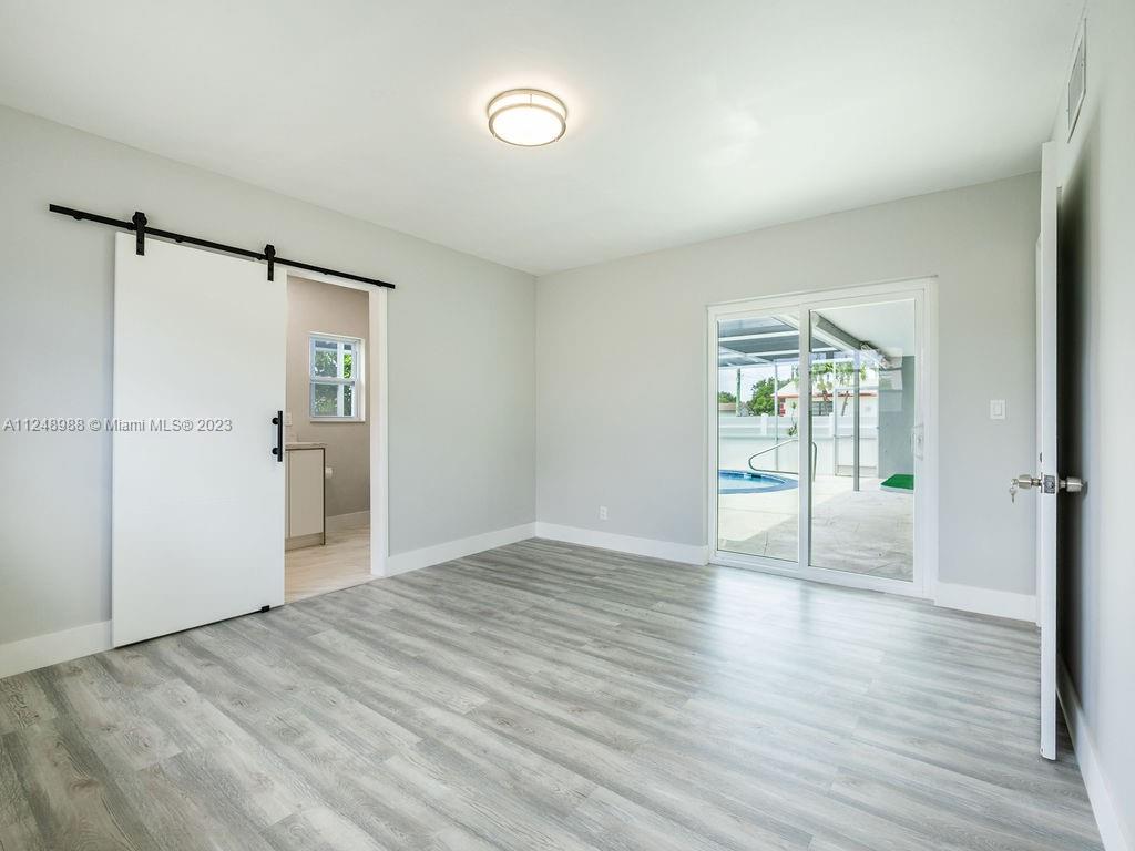 4530 Madison Street Hollywood, FL 33021 - Photo 50 of 94 an empty room with wooden floor and windows