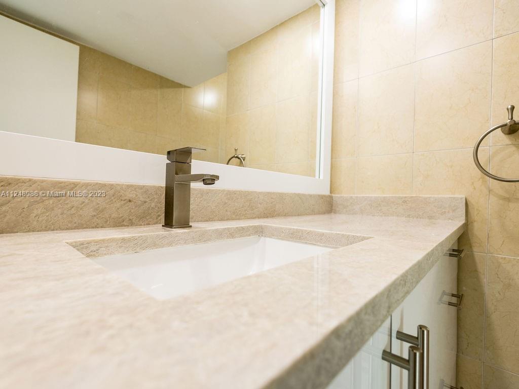 4530 Madison Street Hollywood, FL 33021 - Photo 54 of 94 a bathroom with a sink and a mirror