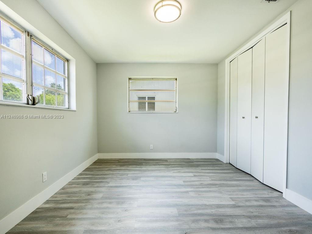 4530 Madison Street Hollywood, FL 33021 - Photo 60 of 94 a view of an empty room with wooden floor and a window