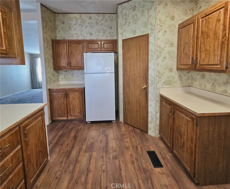 49645 3 Points Road Lancaster, CA 93536 - Photo 16 of 40 a kitchen with a sink wooden floor and stainless steel appliances