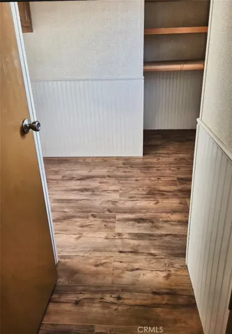 an empty room with a ceiling fan and a window