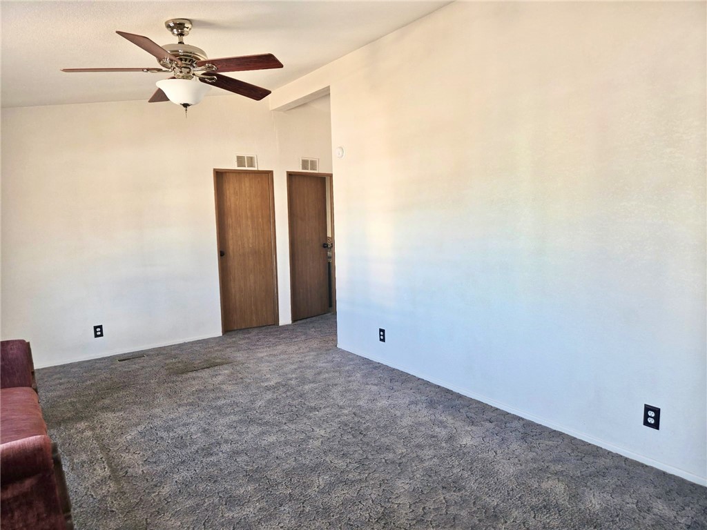 49645 3 Points Road Lancaster, CA 93536 - Photo 23 of 40 an empty room with a ceiling fan and a window