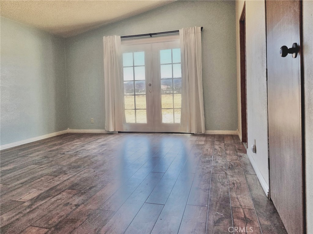 49645 3 Points Road Lancaster, CA 93536 - Photo 28 of 40 a view of an empty room with wooden floor and a window