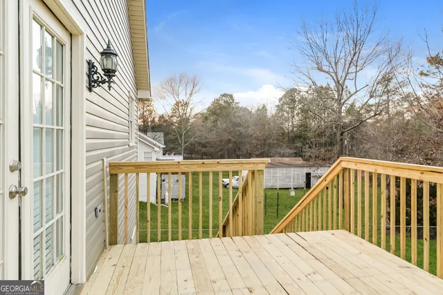 a view of a balcony with wooden floor and fence