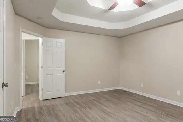 a view of an empty room with wooden floor