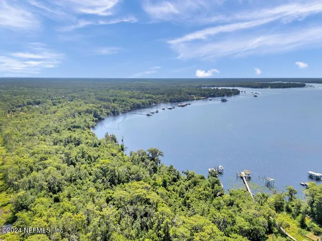 an aerial view of a houses with a yard