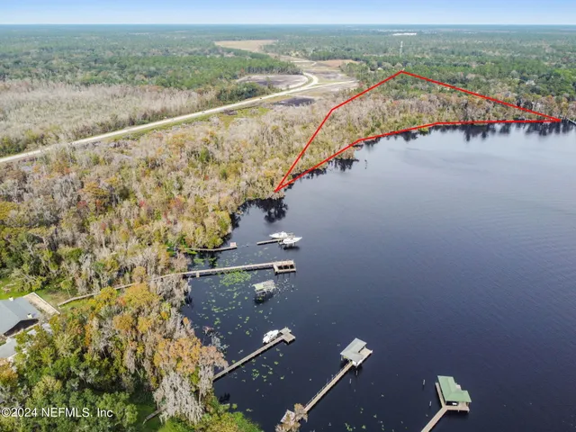 an aerial view of residential building with outdoor space and ocean view