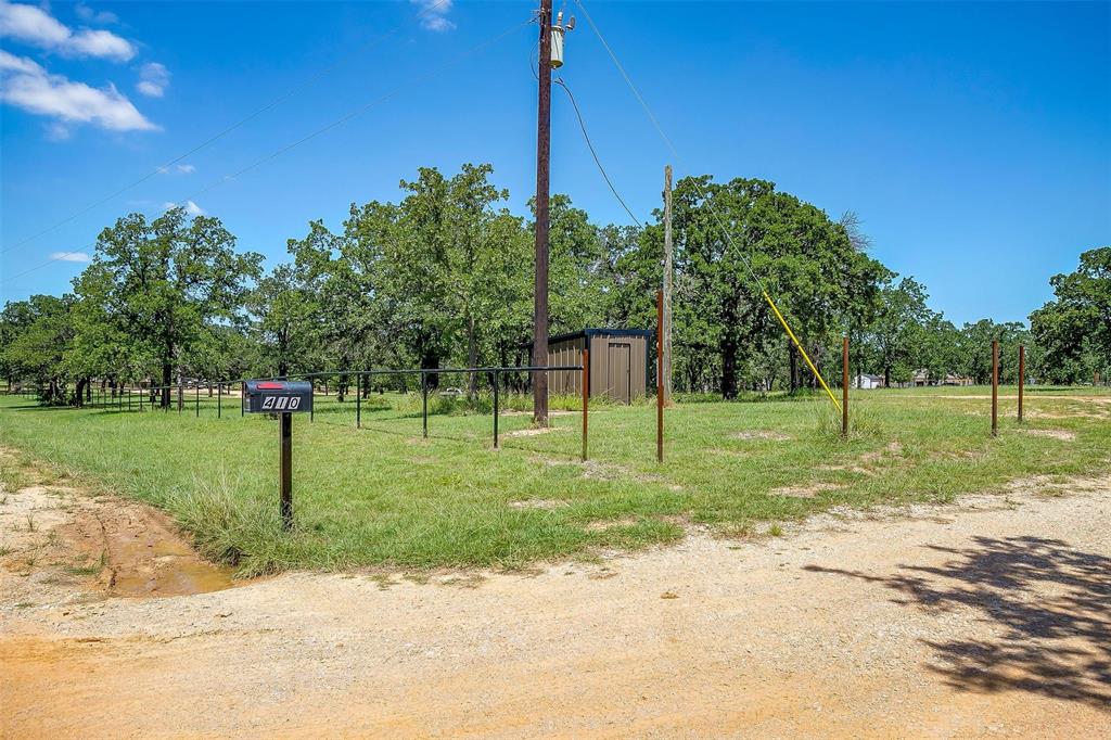 410 Wild Hill Springtown, TX 76082 - Photo 11 of 19 a garden with trees in the background