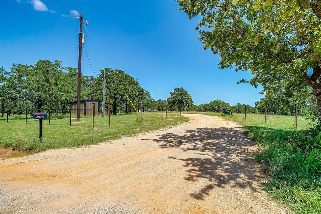 410 Wild Hill Springtown, TX 76082 - Photo 12 of 19 a view of a lake with a big yard