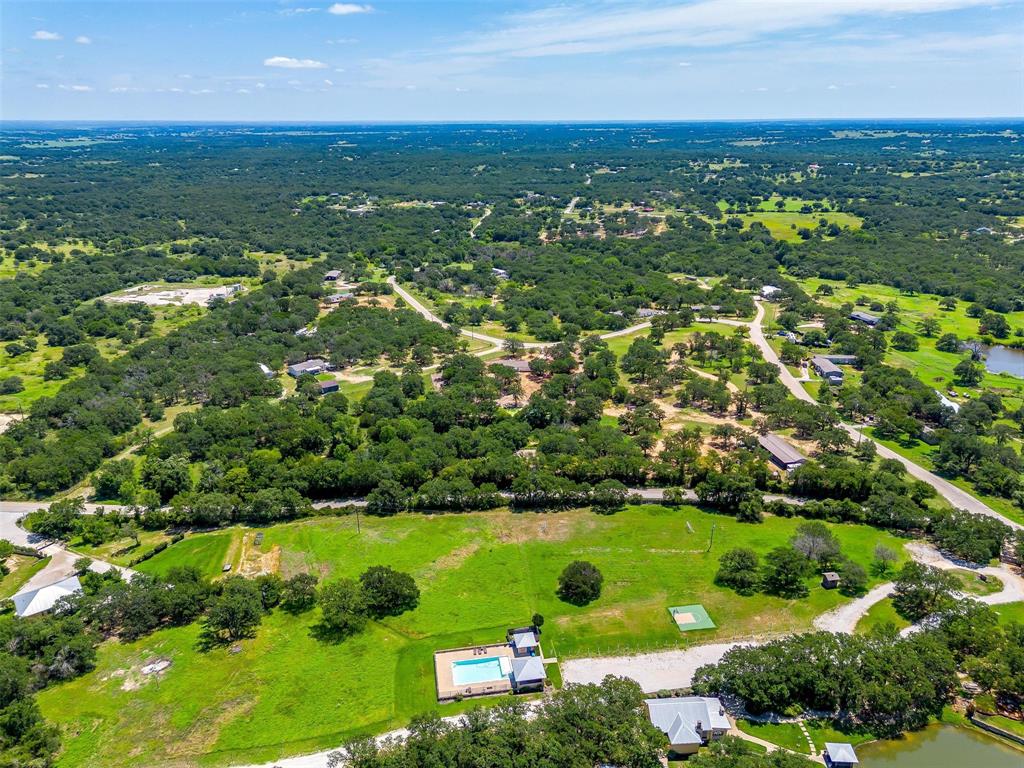 410 Wild Hill Springtown, TX 76082 - Photo 6 of 19 an aerial view of residential houses with outdoor space and trees