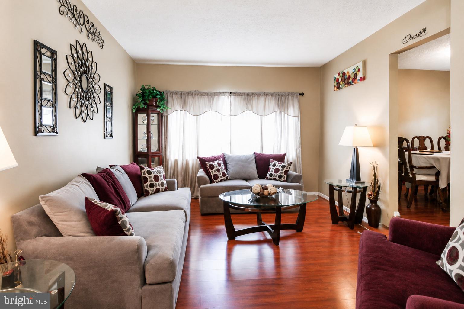 8121 Elizabeth Road Pasadena, MD 21122 - Photo 5 of 27 a living room with furniture and wooden floor