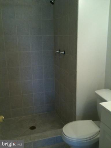7922 Spring Forest Court, Unit 4A Springfield, VA 22152 - Photo 10 of 12 a white toilet sitting next to a shower
