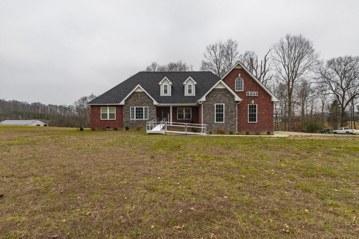 231 Calvert Ridge Road Westmoreland, TN 37186 - Photo 1 of 27 a front view of a house with a yard and garage