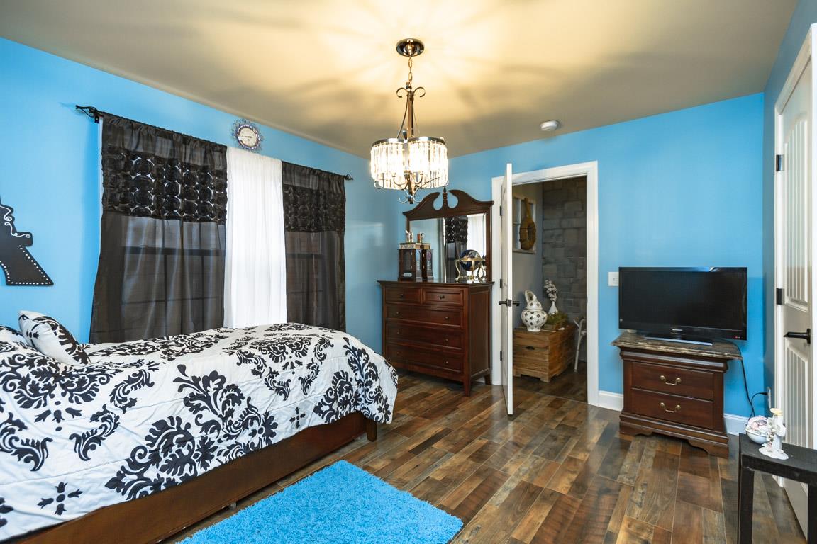 231 Calvert Ridge Road Westmoreland, TN 37186 - Photo 11 of 27 a bedroom with a bed and a flat tv screen on dresser