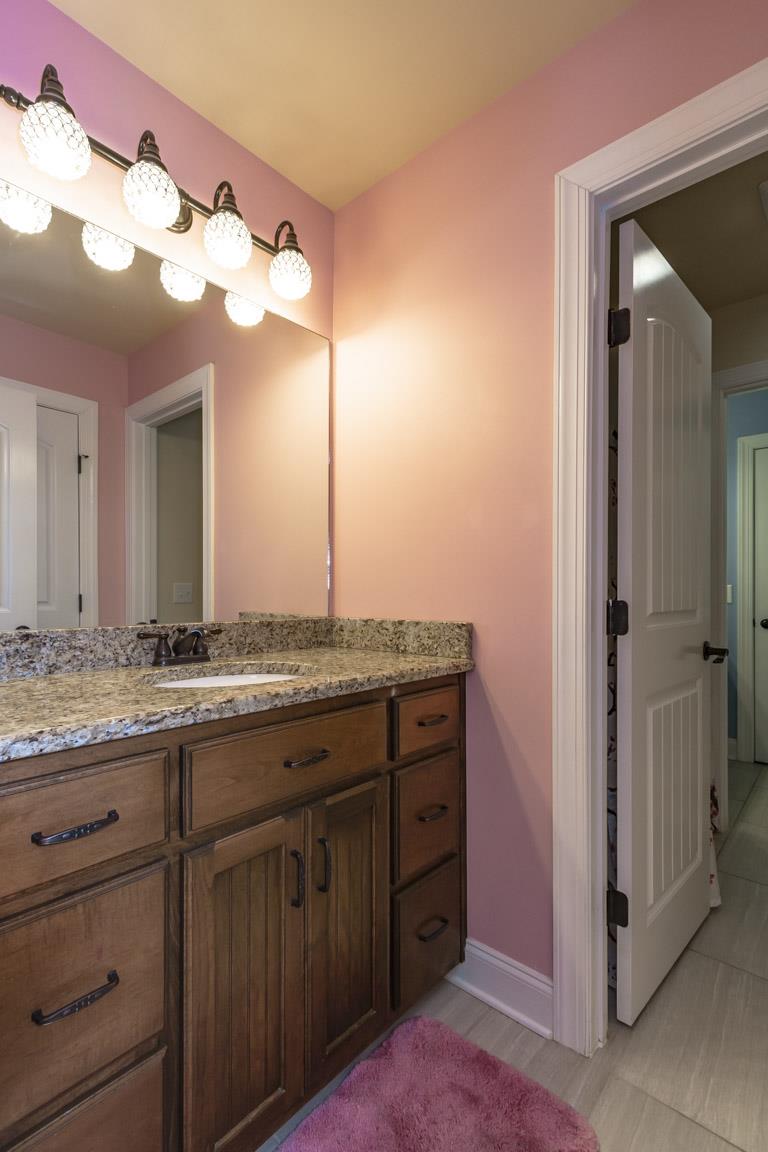 231 Calvert Ridge Road Westmoreland, TN 37186 - Photo 12 of 27 a bathroom with a granite countertop sink and a mirror
