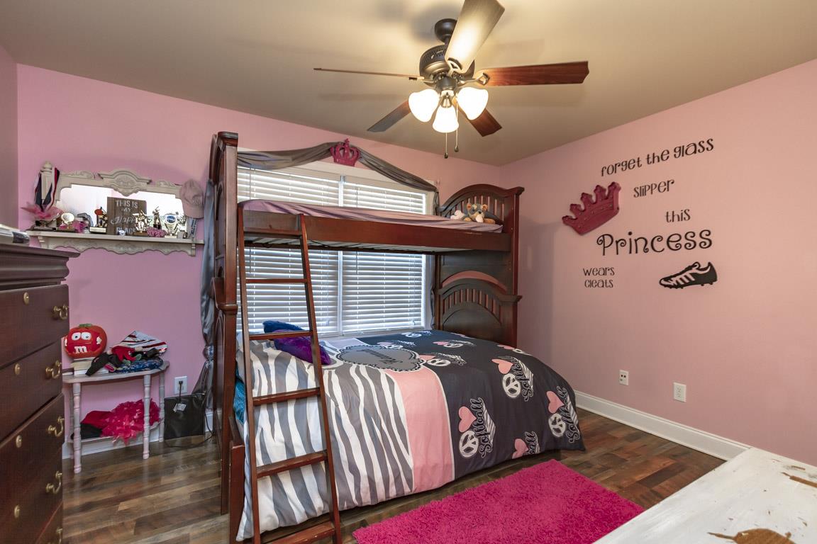 231 Calvert Ridge Road Westmoreland, TN 37186 - Photo 13 of 27 a bedroom with a bed and a chandelier
