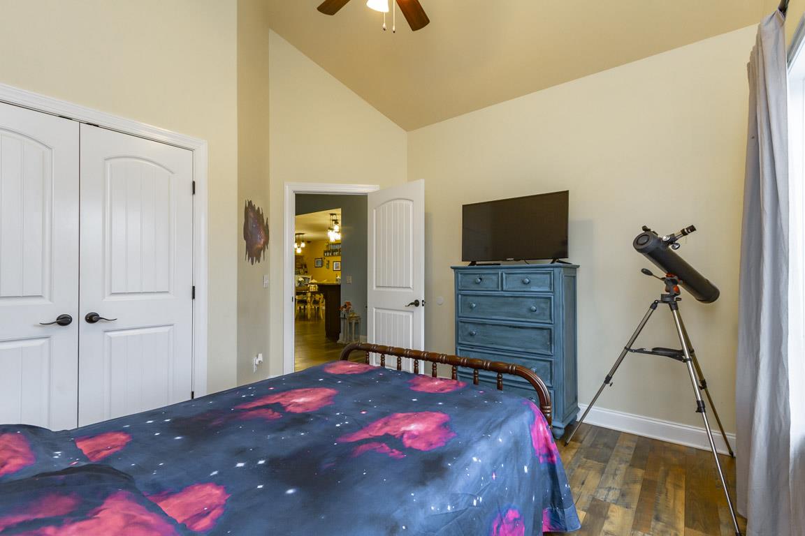 231 Calvert Ridge Road Westmoreland, TN 37186 - Photo 14 of 27 a bedroom with a bed and a flat tv screen on dresser