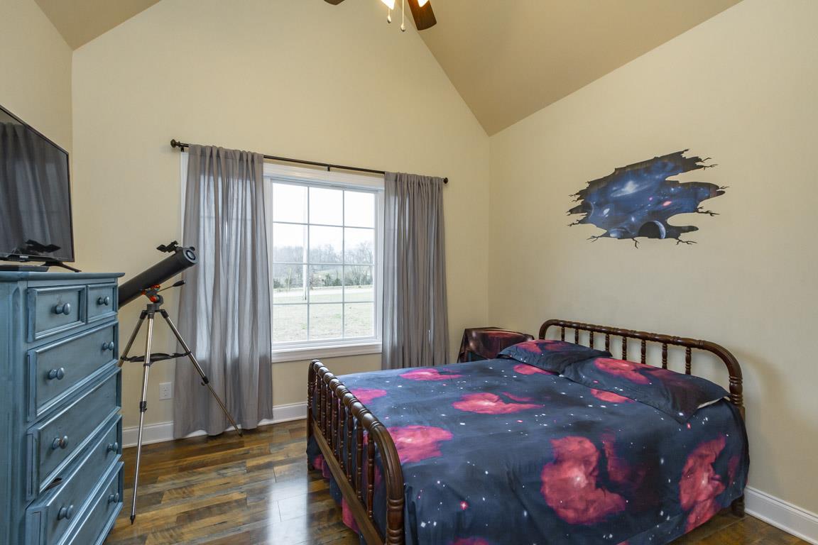 231 Calvert Ridge Road Westmoreland, TN 37186 - Photo 15 of 27 a bedroom with a bed and a flat tv screen on the dresser