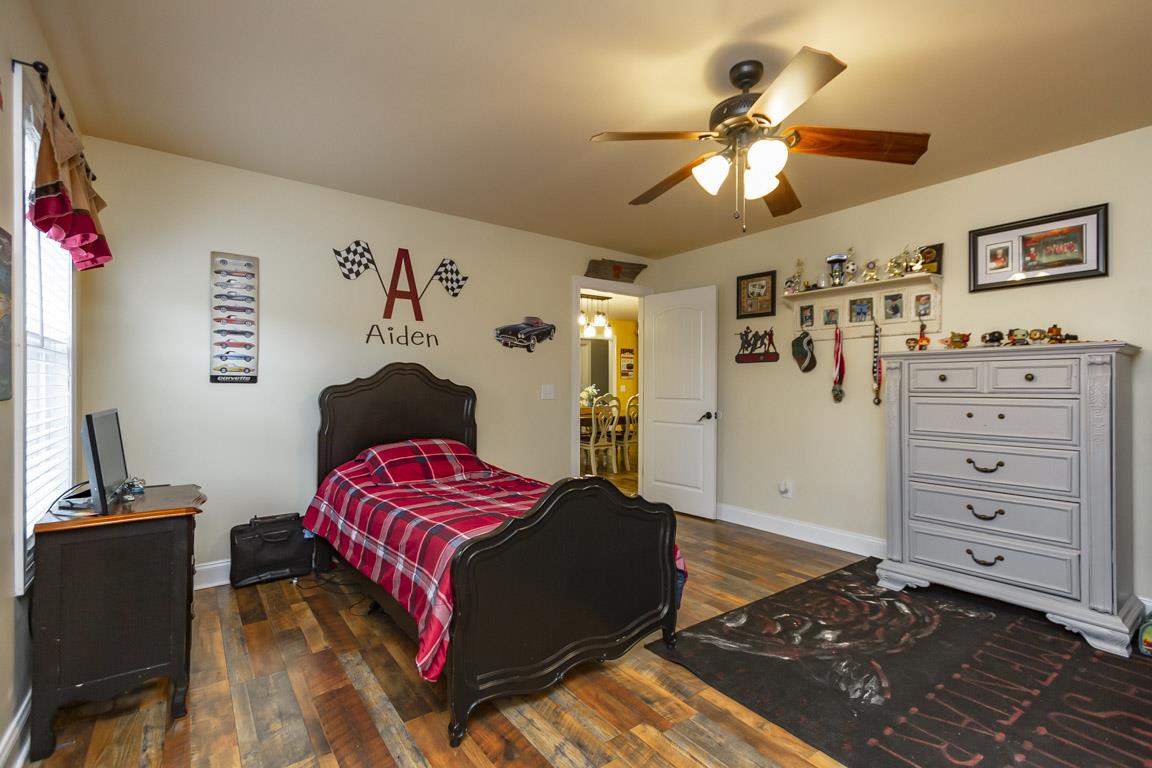 231 Calvert Ridge Road Westmoreland, TN 37186 - Photo 16 of 27 a bedroom with a bed and a chandelier