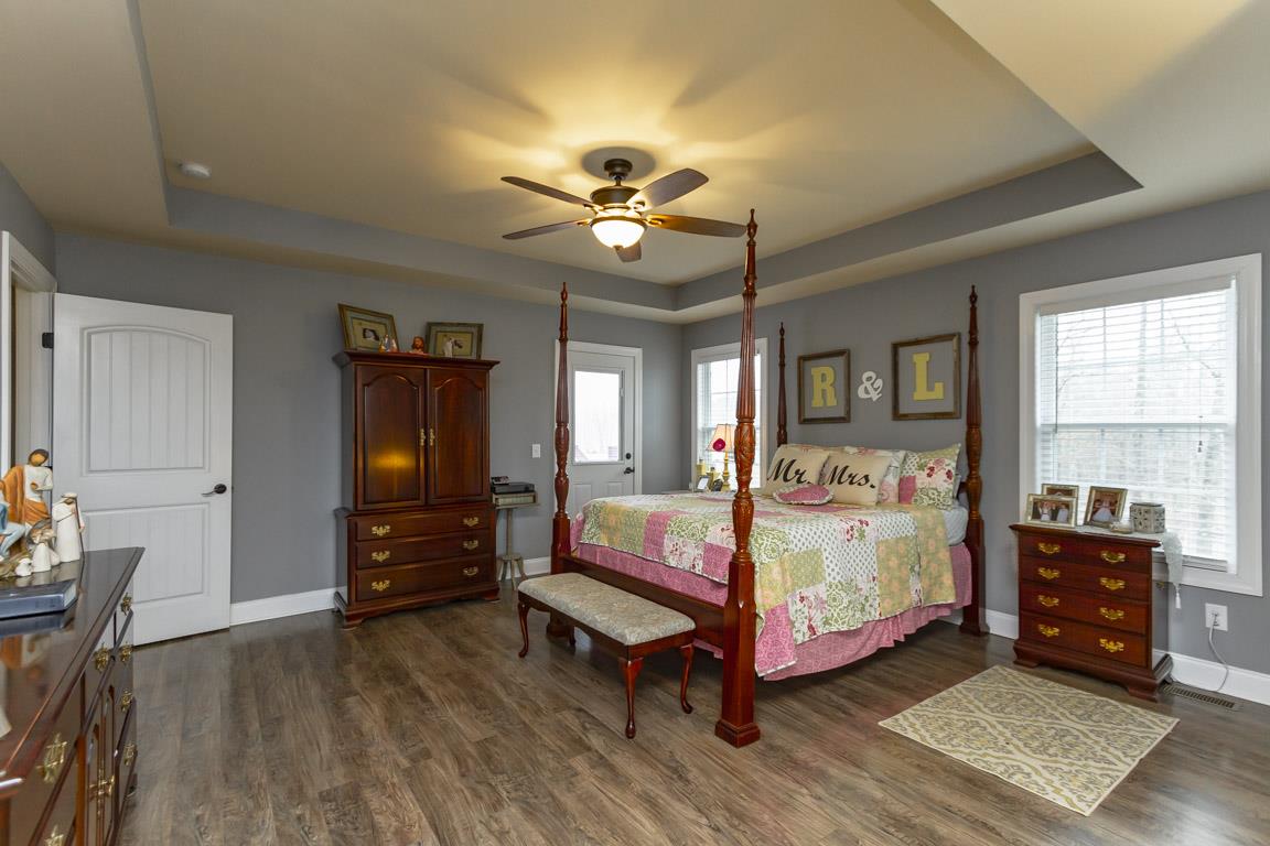 231 Calvert Ridge Road Westmoreland, TN 37186 - Photo 18 of 27 a bedroom with a bed and wooden floor