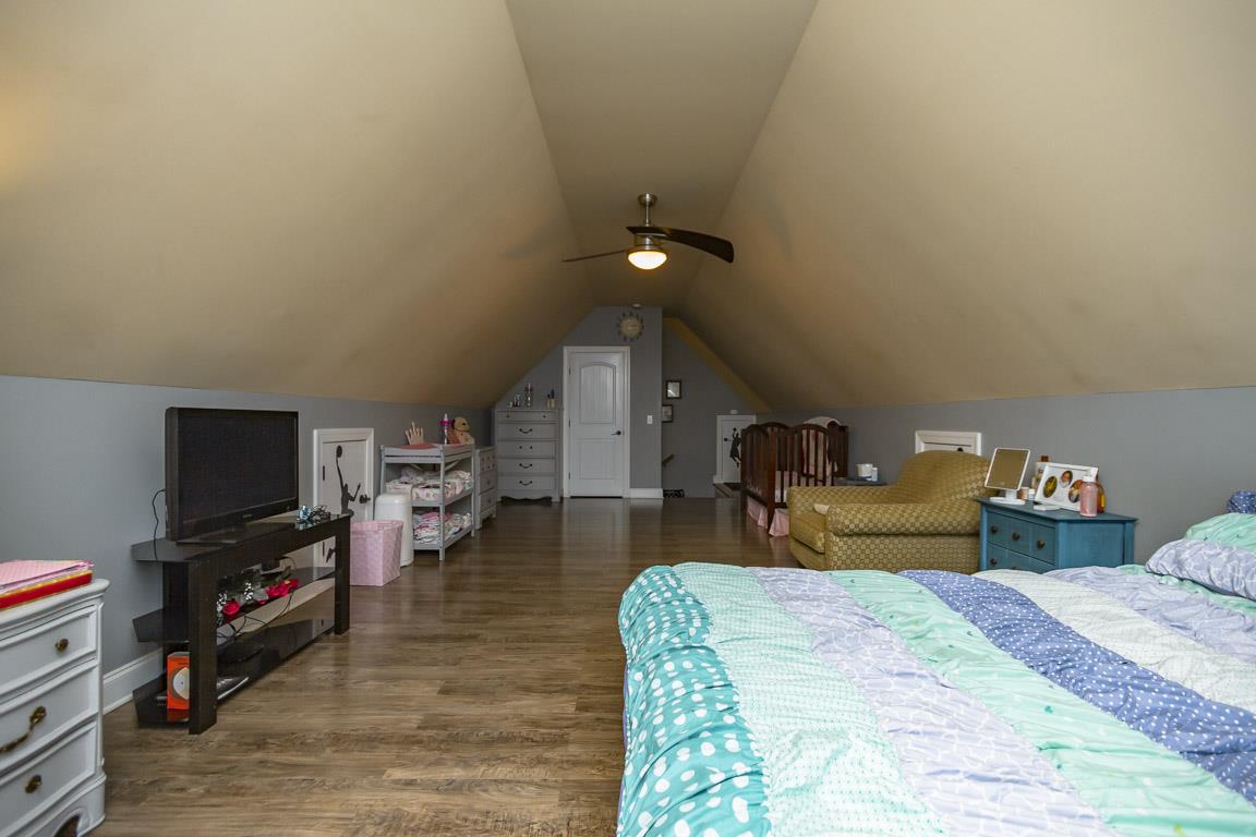 231 Calvert Ridge Road Westmoreland, TN 37186 - Photo 20 of 27 a bedroom with a bed and a flat screen tv