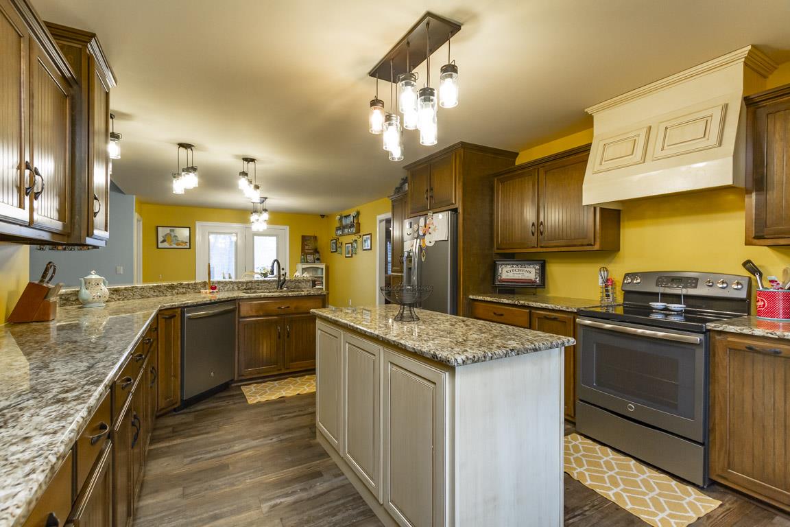 231 Calvert Ridge Road Westmoreland, TN 37186 - Photo 8 of 27 a kitchen with stainless steel appliances granite countertop a sink stove and refrigerator