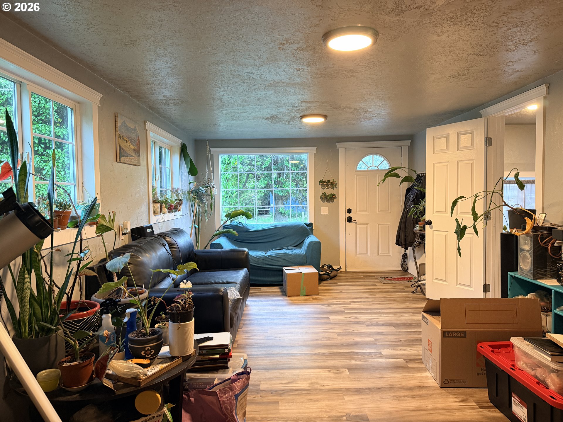 677 Southeast Moffitt Road Waldport, OR 97394 - Photo 6 of 36 a living room with furniture floor to ceiling window and wooden floor