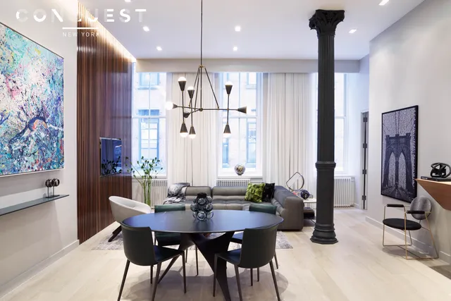a view of a dining room with furniture and chandelier