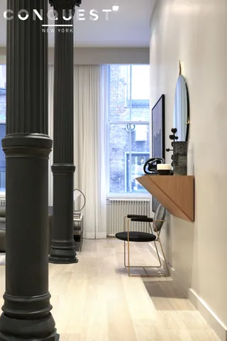 a view of a livingroom with furniture and floor to ceiling window