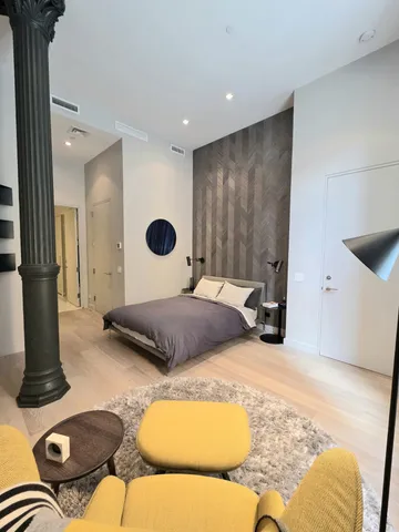 a bedroom with a bed and a dresser