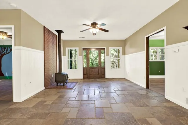 a view of a dining room with furniture a chandelier and wooden floor