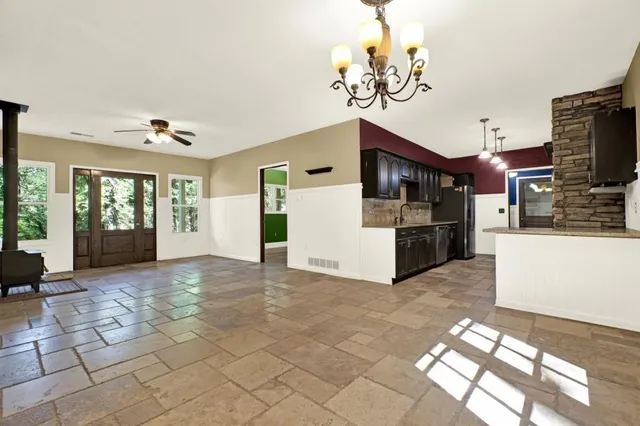 a kitchen with stainless steel appliances granite countertop a refrigerator and a sink