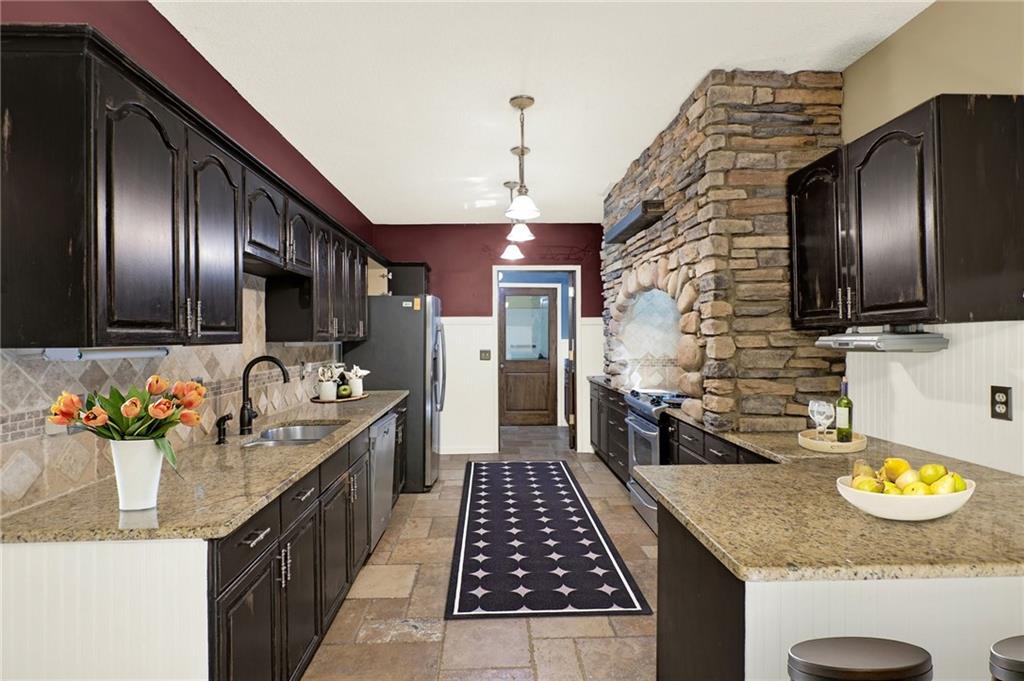 438 East Price Creek Road Jasper, GA 30143 - Photo 23 of 64 a kitchen with granite countertop stainless steel appliances and a sink