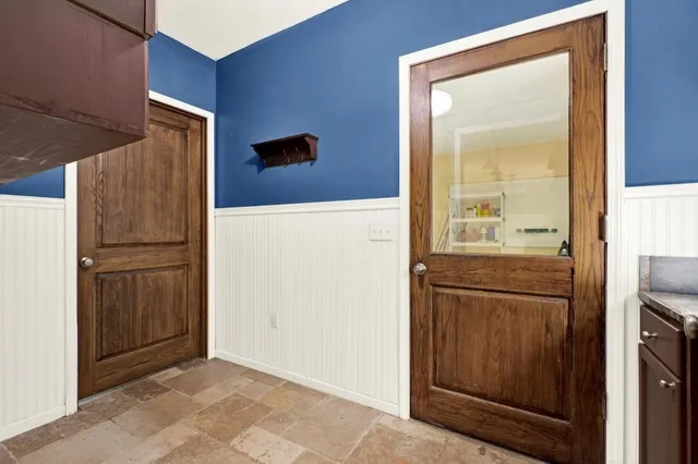 a bedroom with a bed and windows