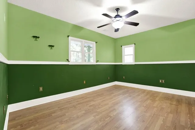 a view of an empty room with wooden floor