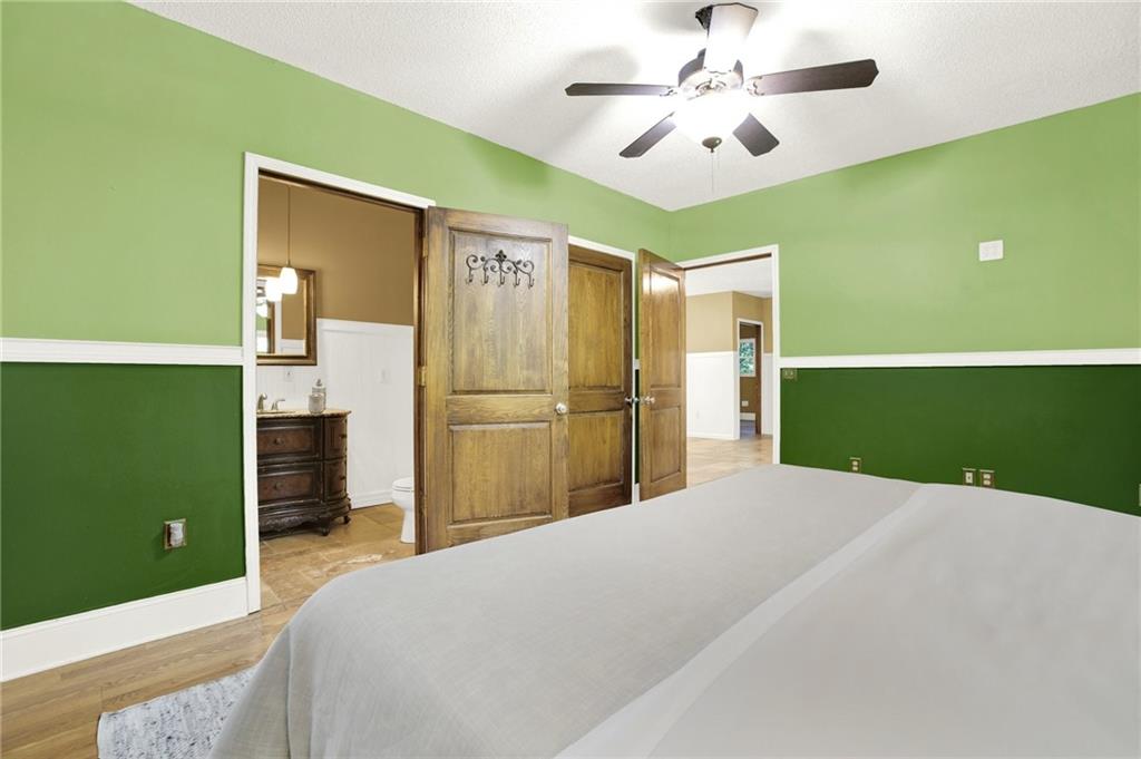 438 East Price Creek Road Jasper, GA 30143 - Photo 33 of 64 a bedroom with a bed and a chandelier