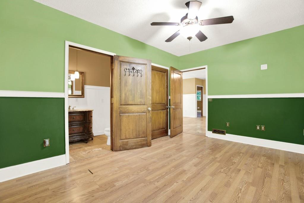 438 East Price Creek Road Jasper, GA 30143 - Photo 34 of 64 a view of a kitchen with a fridge a ceiling fan and wooden floor