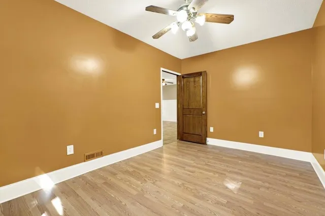 a kitchen with granite countertop a sink window and cabinets